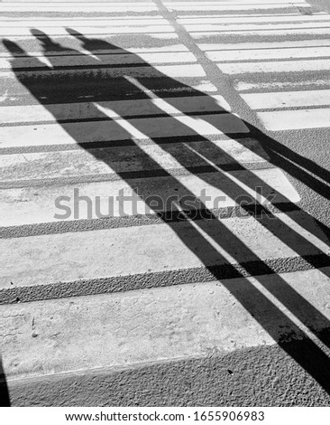 Abstract street pavement background with shadows citizens and stripes zebra crosswalk