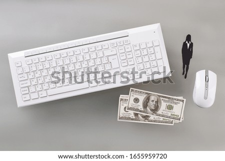 White keyboard and optical mouse on gray surface top view. Salary of financial worker. Business concept.
