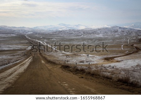 Scenic view of winter road and frozen Baikal Lake, Olkhon Island, Russia
