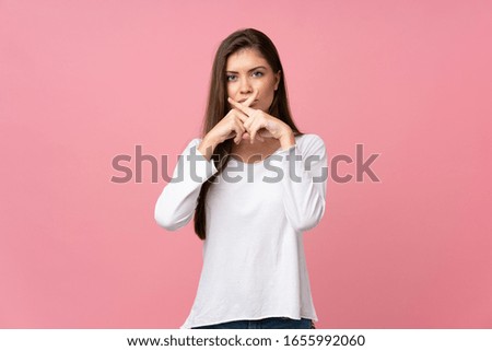 Young woman over isolated pink background showing a sign of silence gesture