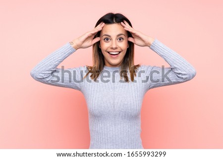 Woman over isolated pink background with surprise expression