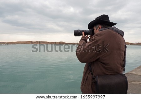 Male photographer taking pictures of  Lake Michigan in Chicago