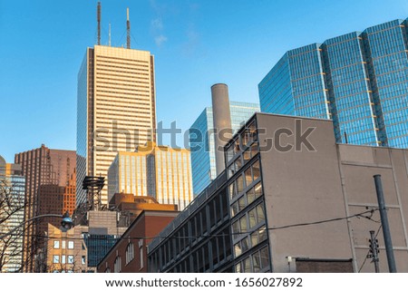 Skyline of a financial district with modern glass office skyscrapers against blue sky at sunset