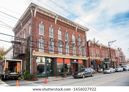 Traditional American brick buildings with stores on the ground floor along a street in a mountain town