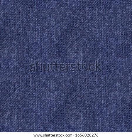 tileable seamless pattern of blue jeans denim texture with acid print of geometric abstract flowers inspired in mandala art style