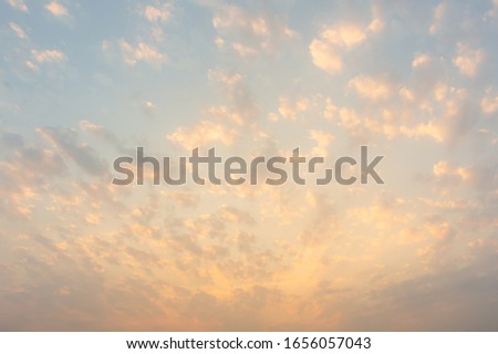Beautiful Vivid sky painted by the sun leaving bright golden shades.Dense clouds in twilight sky in winter evening.Image of cloud sky on evening time.Evening Vivid  sky with clouds. 