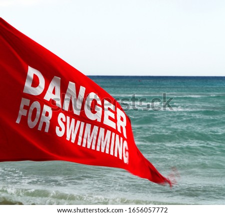 Danger for swimming red flag on the beach.