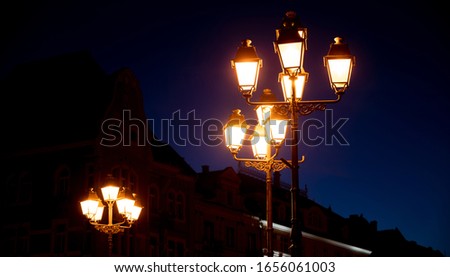 Night lantern illumination in Timisoara, Romania. An antique street lamp in the style of the vintage.
