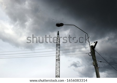 Silhouette of construction elements set against a brooding cloudy stormy sky