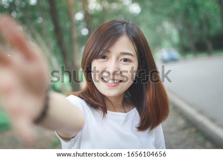 Happy woman check hand to front camera.