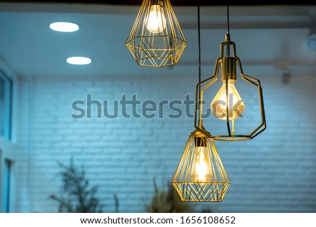 Warm light bulbs in coffee shops,Get and idea concept with copy space. Royalty-Free Stock Photo #1656108652