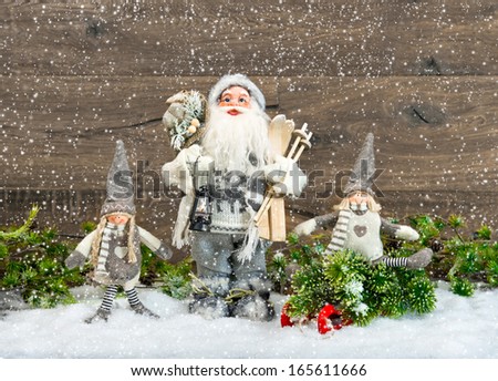 Cute Santa Claus and happy kids in snow. Christmas decoration. Vintage style toned picture with falling snow effect