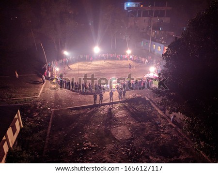 Local Stadium for cricket match.People around the playground in Night of top view. There are crowds around the middle of the night to watch the game.Top view and Arial photography.