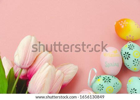 Table top view shot of decorations Happy Easter holiday background concept.Flat lay simple minimal bunny eggs & with tulip on modern rustic pink paper.Copy space for creative design mock up & template
