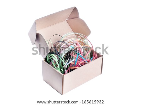 colored pieces of paper in a cardboard box on a white background