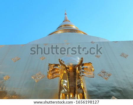 golden pagoda with gold elephant statue