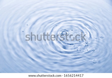 Water drop and wave splash in white ceramic bowl