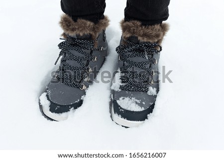 Picture of a comfortable women's warm boots in the snow