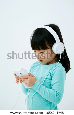 Korean little girl listening music 