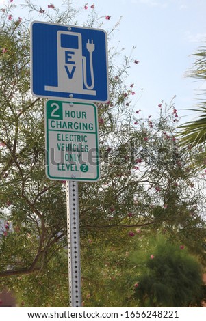 a sign for an electrical charging station conveniently located next to a public parking lot 3960