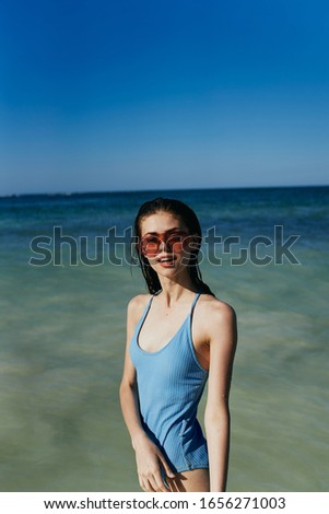 young woman with a beautiful figure in a swimsuit on the sea