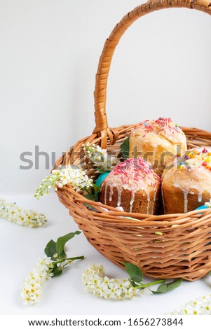 Easter cakes. Easter eggs in a wicker basket. white cherry flowers. homemade easter baking