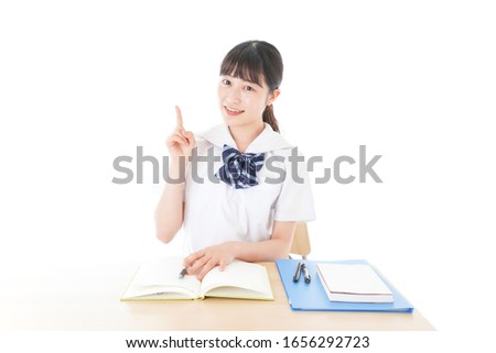 Uniformed young student pointing to something