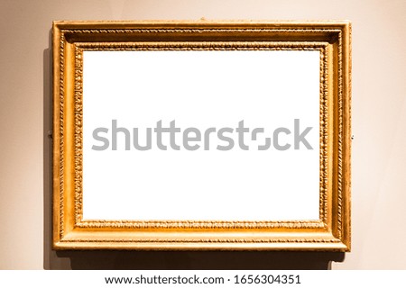 horizontal vintage painting frame with cutout canvas hangs on wall lit by electric light