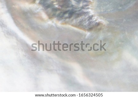 Abstract blurred pearl background with shimmering hues of lilac, turquoise, mauve and cream colours Royalty-Free Stock Photo #1656324505