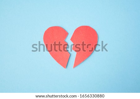 Red paper broken heart on bright background. Divorce, parting, therapy, love, psychologist, family ruined concept Royalty-Free Stock Photo #1656330880