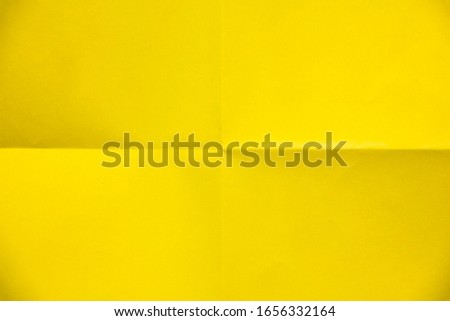 Folded sheets of yellow paper, isolated on white and black background