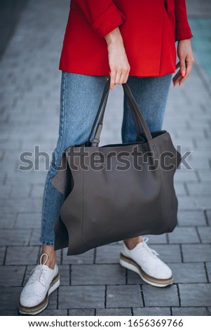 Summer girl posing with bags outside the city