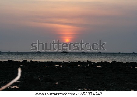 Blurred and Noises Photograph of Sunset views along the beach with trees, at Kota Kinabalu, Sabah, Malaysia