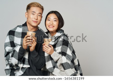 Checkered plaid young people with drinks in their hands