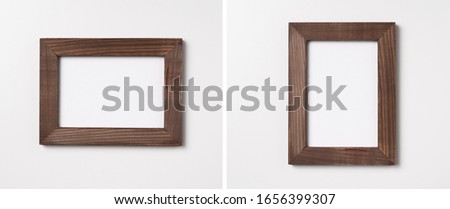 Design concept - top view of brown wood photo frame isolated on white background for mockup, it's real photo, not 3D render