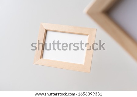 Design concept - top view of two brown wood photo frame float on mid air with blur effect isolated on white background for mockup, it's real photo, not 3D render