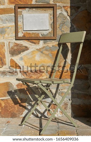 Old foldable chair in the sun with shadow