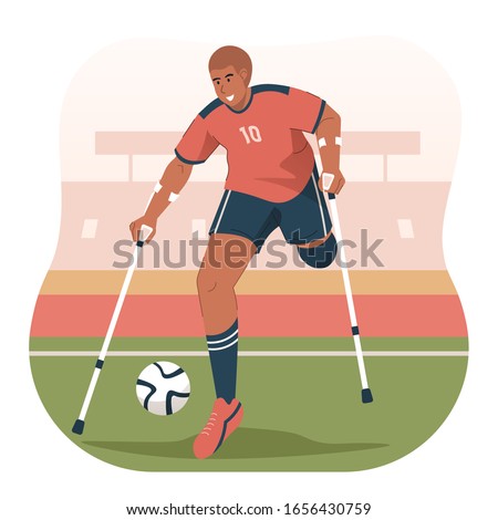 Disabled man with crutches playing football in stadium. Paralympic soccer athlete
