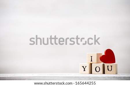 Love message written in wooden blocks. Royalty-Free Stock Photo #165644255