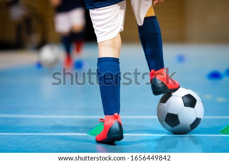Indoor futsal soccer players playing futsal match. Indoor soccer sports hall. Futsal players kicking match. Futsal training dribbling drill. Sports background. Indoor soccer league. Royalty-Free Stock Photo #1656449842