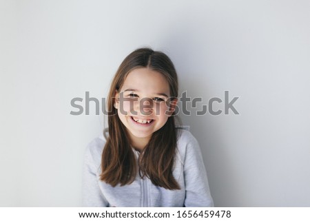 Funny brunette girl, have an idea and smile wearing panda glasses