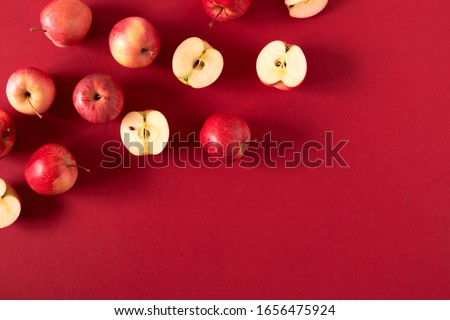 Red apples on red background. Apples as background. Flat lay, top view, copy space