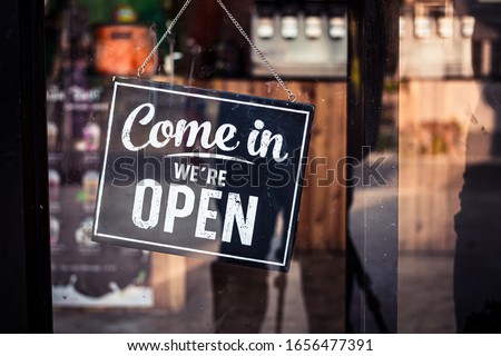 Come in we're open, vintage retro sign in cafe front Royalty-Free Stock Photo #1656477391
