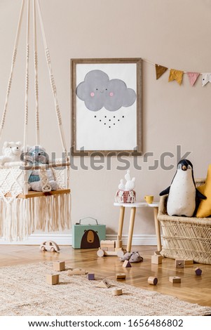 Stylish scandinavian interior of kid room with mock up poster frame, design furnitures, natural toys, hanging colorful flags, plush animals, child accessories and teddy bears. Modern home decor.