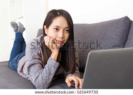 Asian woman looking at computer screen