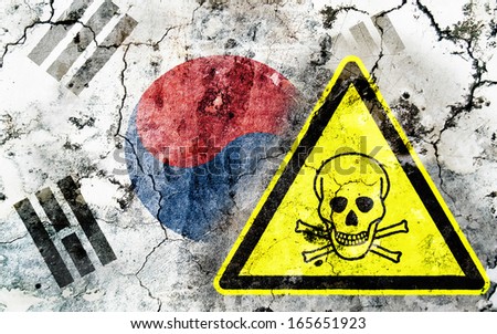 Old cracked wall with poison warning sign and painted flag, flag of South Korea