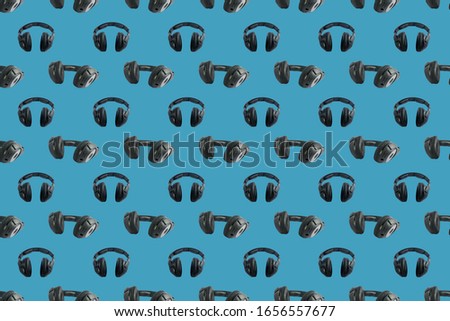 Wireless black headphones on colorful background. Square pattern for different design purposes, seamless flat lay