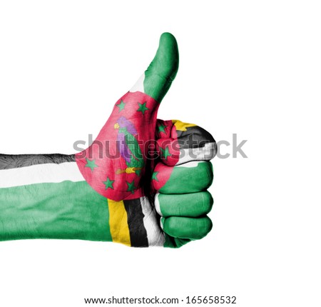 Closeup of male hand showing thumbs up sign, flag of Dominica