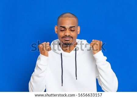 African guy wearing a white sweatshirt on a blue background