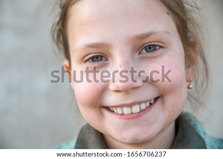 Portrait of a little, young cute smiling girl, a close-up